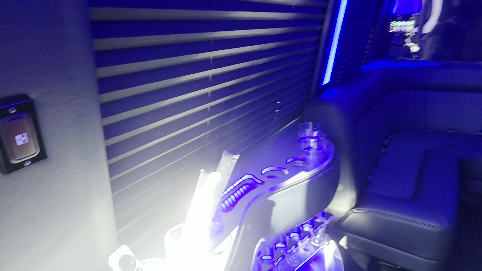 Sprinter cabin console with glassware and ambient lighting along the side